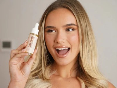 Creator holding SOLSKIN skincare